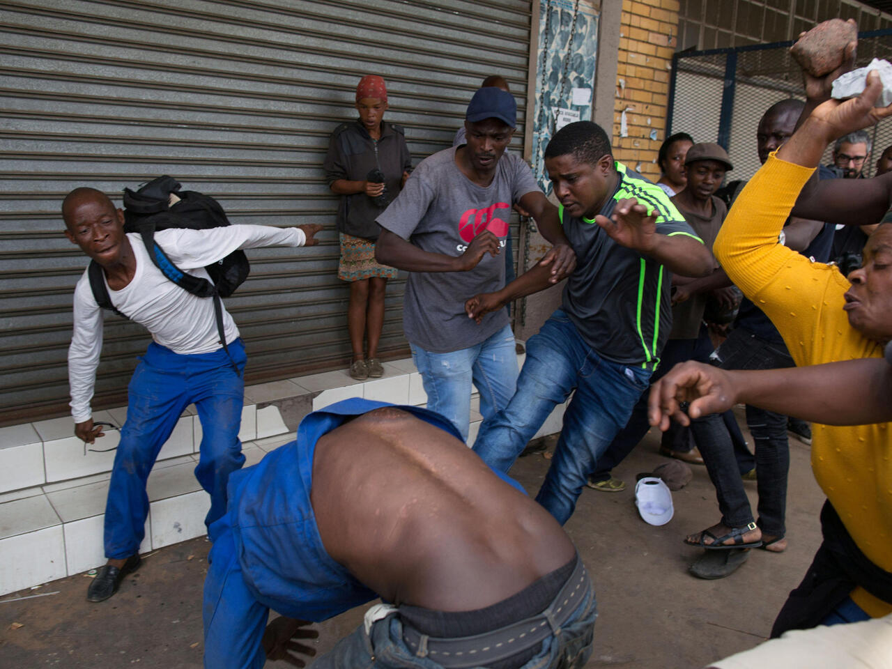 A vigilante mob attacks a Nigerian migrant outside a church in Pretoria, South Africa February 18, 2017. REUTERS/James Oatway FOR EDITORIAL USE ONLY. NO RESALES. NO ARCHIVES  TPX IMAGES OF THE DAY